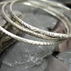 Animal print patterns acid etched onto sterling silver bangles. Including leopard, dalmatian and zebra print.