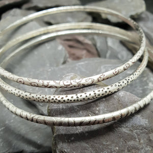 Animal print patterns acid etched onto sterling silver bangles. Including leopard, dalmatian and zebra print.