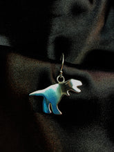 Load image into Gallery viewer, Cartoon style T-Rex made in silver presented on a silver hook earring.