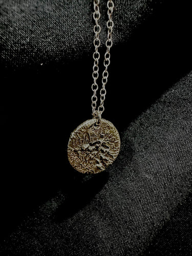 Reticulated sterling silver moon presented on a silver chain.